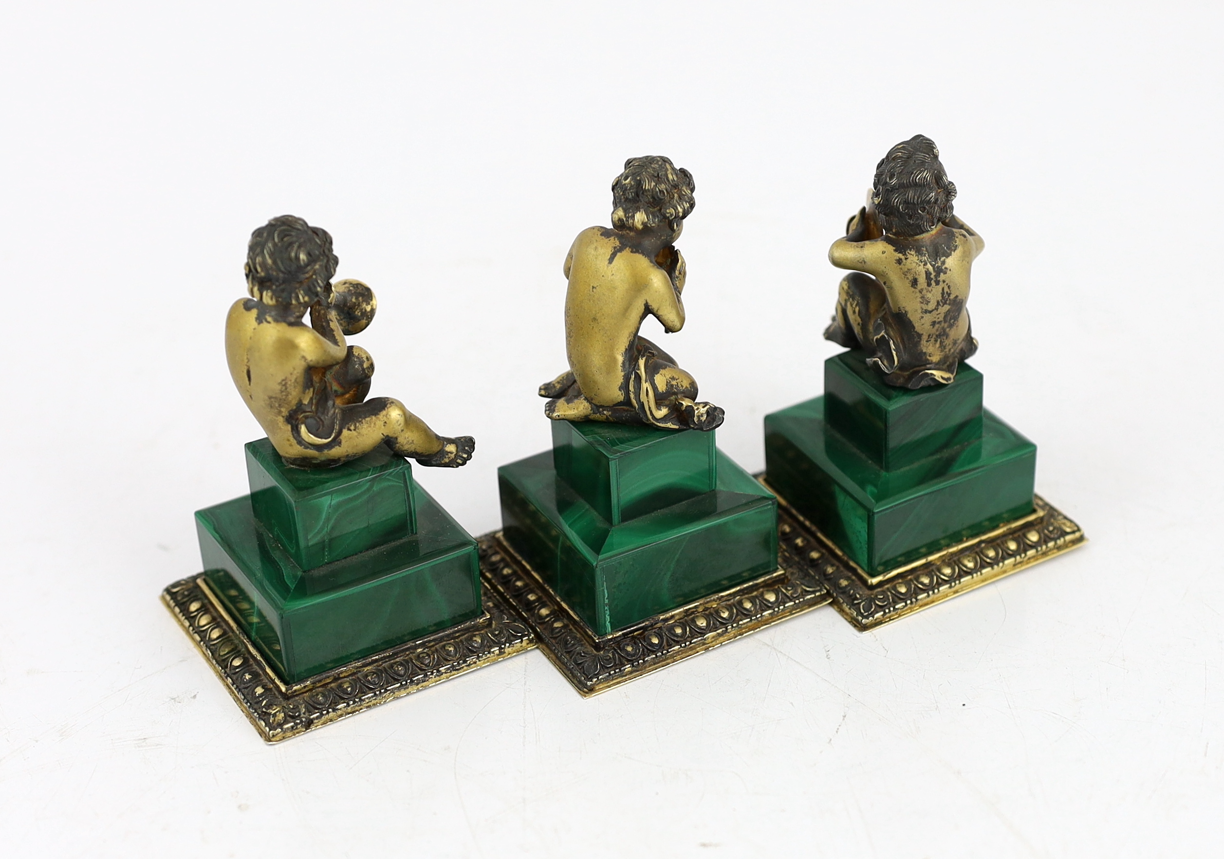A set of three Italian silver gilt figures of musical putti, 5.5cm wide, 5.5cm deep, 9cm high